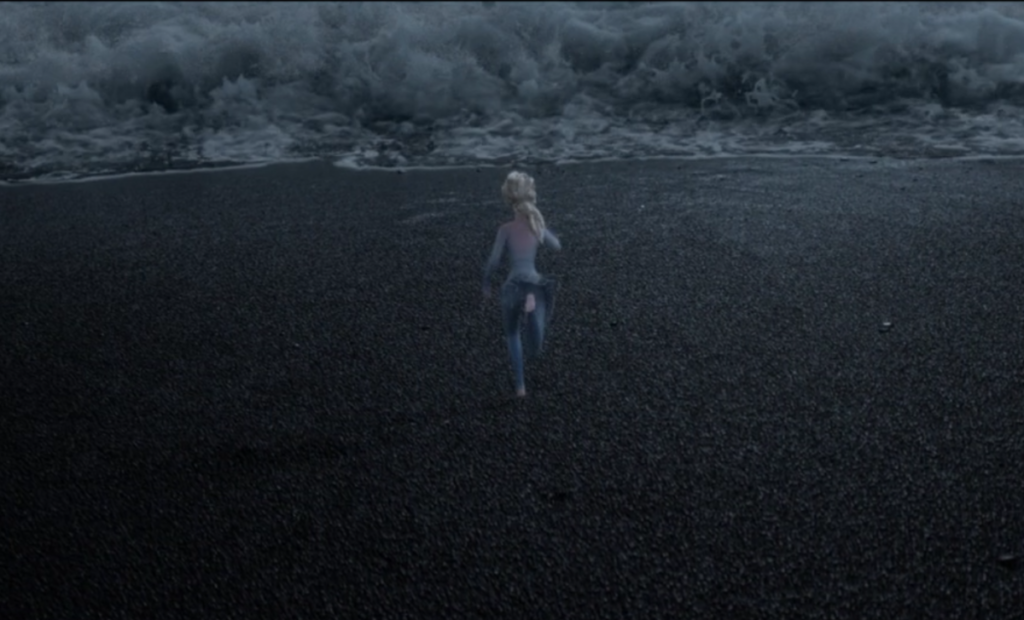 Elsa Running along the Black Sand Beach in Iceland